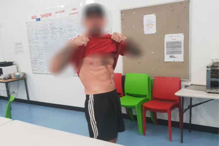 Ben Hoffmann raises his shirt for a selfie