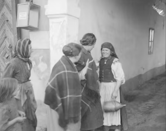 A black and white photo dated 1914 of village women in traditional costume